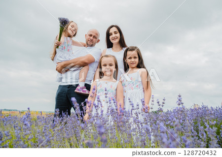 The girls in their white dresses look adorable in the purple lavender field The girls in their white dresses look adorable in the purple lavender field 128720432