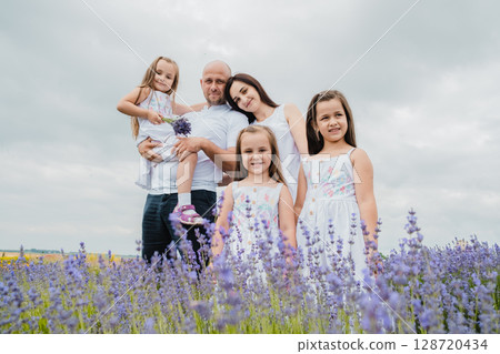 The family stands in the lavender field The family stands in the lavender field 128720434