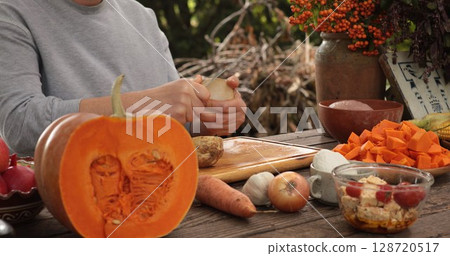 Thanksgiving dinner preparation with fresh vegetables and autumn harvest at outdoor kitchen Thanksgiving dinner preparation with fresh vegetables and autumn harvest at outdoor kitchen 128720517