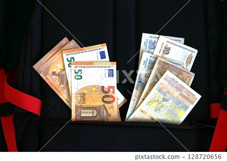 Euro and Bulgarian lev banknotes stored together in backpack compartment for travel or savings. Concept of dual currency, financial planning, EU expansion, currency transition 128720656