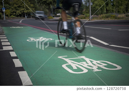 Cyclist using green cycle lane 128720738