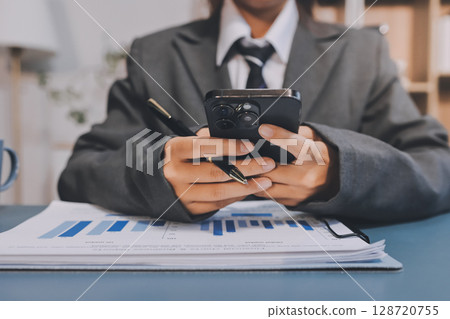 Asian business man using cell phone. Having Conversation, typing sms or presenting. 128720755