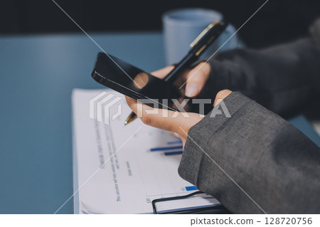 Asian business man using cell phone. Having Conversation, typing sms or presenting. 128720756