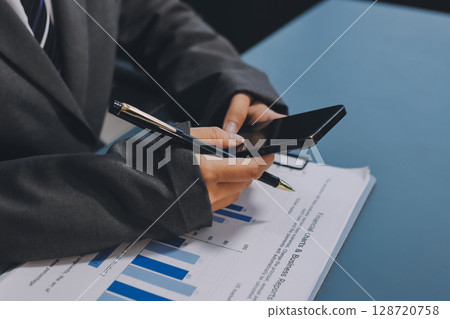 Asian business man using cell phone. Having Conversation, typing sms or presenting. 128720758