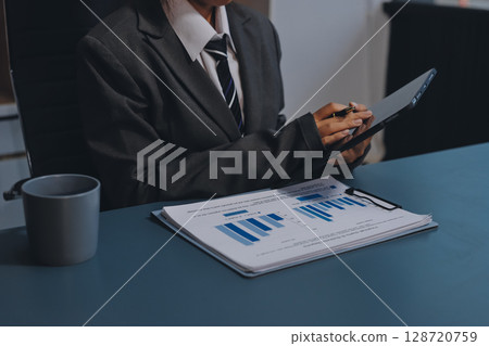 Accounting company provide finance and taxation planning for profitable cash flow, Auditor and accountant team working in office, analyze financial data and accounting record with calculator.Insight 128720759