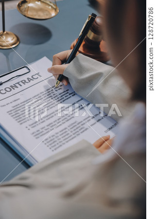 Judge gavel with Justice lawyers having team meeting at law firm background. Concepts of Law and Legal services. Judge gavel with Justice lawyers having team meeting at law firm background. Concepts of Law and Legal services. 128720786