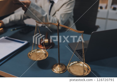 Judge gavel with Justice lawyers having team meeting at law firm background. Concepts of Law and Legal services. 128720791