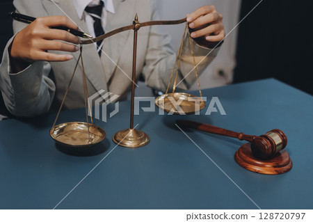 Judge gavel with Justice lawyers having team meeting at law firm background. Concepts of Law and Legal services. Judge gavel with Justice lawyers having team meeting at law firm background. Concepts of Law and Legal services. 128720797