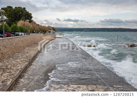 Storm waves crashing over stone pier in Novigrad, Croatia. 128720815