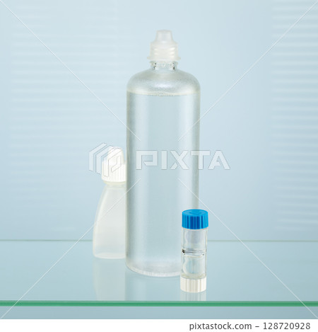 Contact lenses. Ophthalmology composition with containers with night contact lenses, moisturizing eye drops and clean solution. Advertising contact lenses for vision. Optical store 128720928