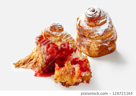Delicious cruffin filled with strawberry jam and icing sugar on white background Delicious cruffin filled with strawberry jam and icing sugar on white background 128721165