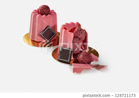 Delicious pink ruby chocolate modern pastry with raspberry filling revealing its content Delicious pink ruby chocolate modern pastry with raspberry filling revealing its content 128721173