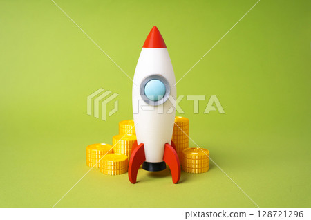 Rocket and money coins. Fundraising for a startup. Funding, angel investment. Business acceleration, venture capital interest. Crowdfunding in launching innovative startup ideas. 128721296