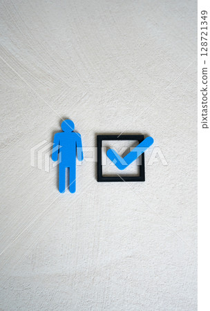 A human figure and a check mark in a checkbox. The concept of compliance with criteria. To mark oneself with one's presence. To be chosen. Meeting job or legal requirements. A human figure and a check mark in a checkbox. The concept of compliance with criteria. To mark oneself with one's presence. To be chosen. Meeting job or legal requirements. 128721349