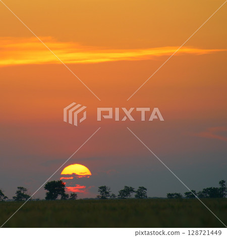 Solar disk and beautiful red sunset over the earth's surface. Solar disk and beautiful red sunset over the earth's surface. 128721449