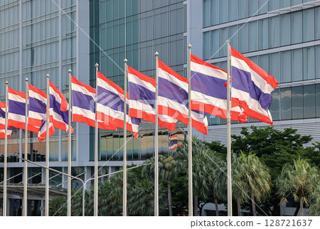 Thai national flags row at Modern building facade. 128721637
