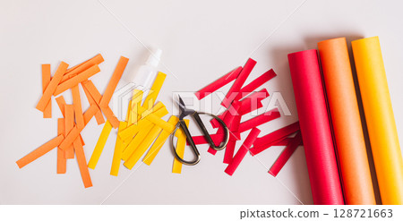 Strips of colored paper, scissors and glue to make paper garlands top view web banner Strips of colored paper, scissors and glue to make paper garlands top view web banner 128721663