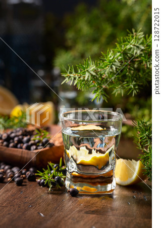 Gin with ingredients on an old wooden table. 128722015