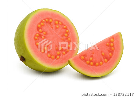 Fresh Guava Fruit Showing Vibrant Pink Flesh and Seeds With a Slice Beside It 128722117