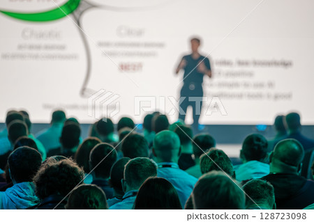 Speaker addressing audience during a professional seminar with presentation screen Speaker addressing audience during a professional seminar with presentation screen 128723098