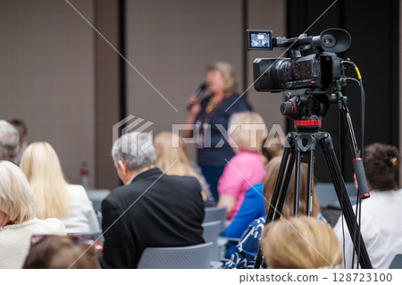 Video recording during a business event with audience in attendance 128723100