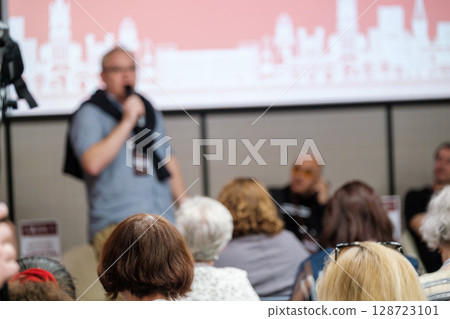 Speaker addressing an audience during a conference or seminar event Speaker addressing an audience during a conference or seminar event 128723101