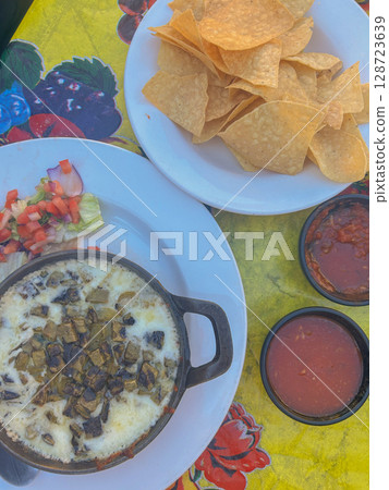 Queso fundido with green chiles, chips and salsa in Tucson, Arizona 128723639