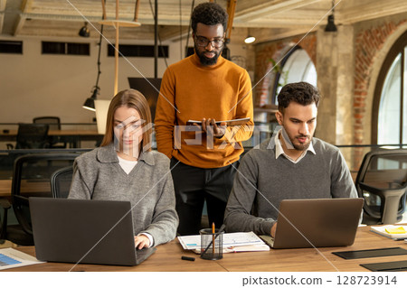 Colleagues working in the office and looking busy 128723914