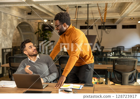 Colleagues working in the office and looking busy Colleagues working in the office and looking busy 128723917