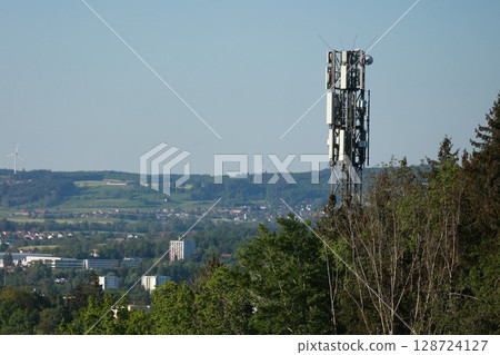 A tall tower with a lot of antennas on top of it 128724127