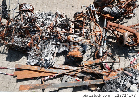 A pile of rusted metal and burnt debris 128724178