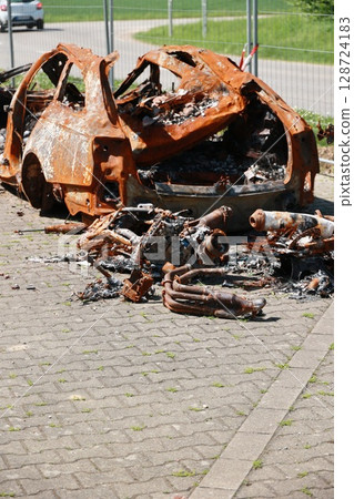 A car is on fire and has been destroyed 128724183