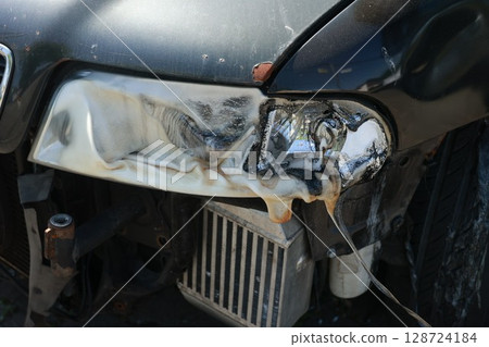 A car's headlight is melted and burnt A car's headlight is melted and burnt 128724184