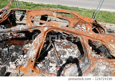 A car is on fire and has been destroyed 128724190
