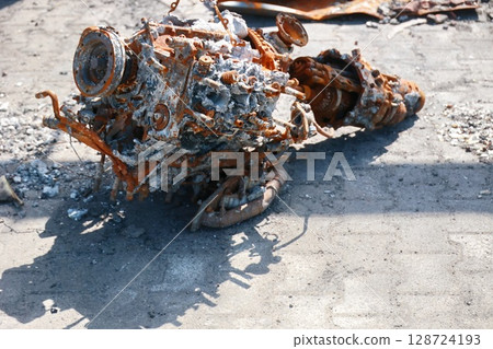 A rusted engine is sitting on the ground A rusted engine is sitting on the ground 128724193