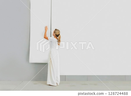 Woman applying blank white wallpaper roll to wall, ai generated 128724488