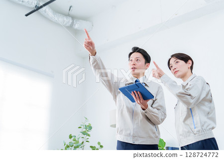Worker inspecting the ceiling 128724772