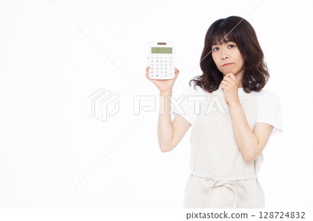 A housewife holding a calculator A housewife holding a calculator 128724832