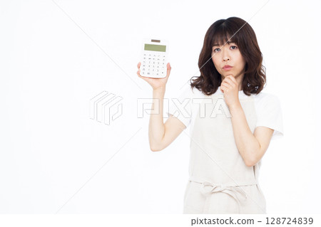 A housewife holding a calculator A housewife holding a calculator 128724839