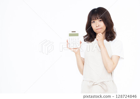A housewife holding a calculator A housewife holding a calculator 128724846