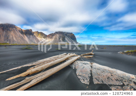 Amazing sunny day and dramatic black sand beach on Stokksnes cape in Iceland 128724963