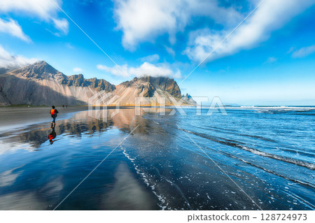 Amazing sunny day and gorgeous reflection of Vestrahorn mountaine on Stokksnes cape in Iceland. Amazing sunny day and gorgeous reflection of Vestrahorn mountaine on Stokksnes cape in Iceland. 128724973