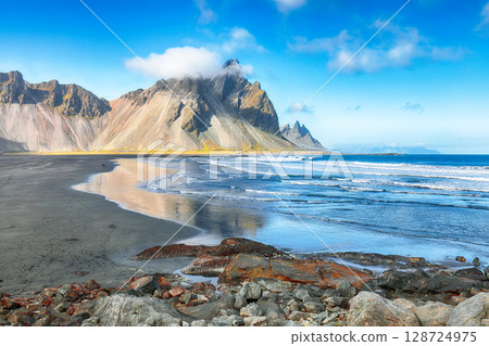 Amazing sunny day and dramatic black sand beach on Stokksnes cape in Iceland 128724975