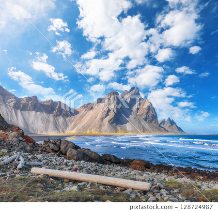 Amazing sunny day and dramatic black sand beach on Stokksnes cape in Iceland Amazing sunny day and dramatic black sand beach on Stokksnes cape in Iceland 128724987