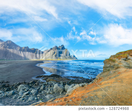 Amazing sunny day and dramatic black sand beach on Stokksnes cape in Iceland Amazing sunny day and dramatic black sand beach on Stokksnes cape in Iceland 128724988