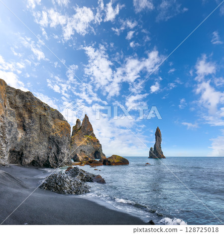 Impressive landscape with basalt rock formations Troll Toes on Black beach Reynisfjara near the village of Vik. Impressive landscape with basalt rock formations Troll Toes on Black beach Reynisfjara near the village of Vik. 128725018