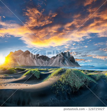 Remarkable sunset with gorgeous black sand dunes on Stokksnes cape in Iceland. Remarkable sunset with gorgeous black sand dunes on Stokksnes cape in Iceland. 128725027