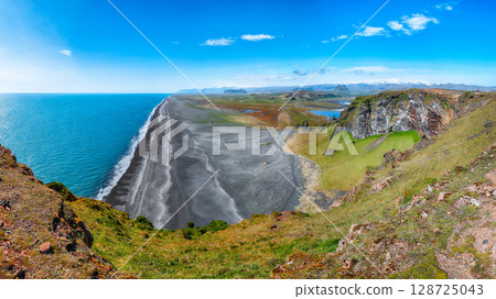 Impressive View of Kirkjufjara black sand beach from Dyrholaey promontory on Atlantic South Coast 128725043