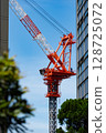 A construction crane can be seen between the buildings. 128725072