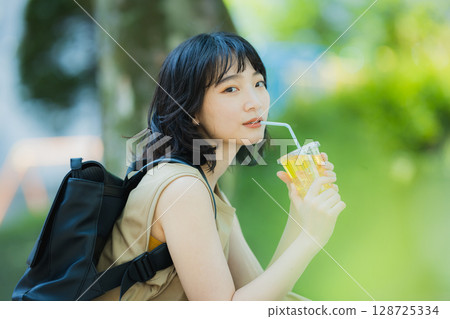 A woman walking in green 128725334